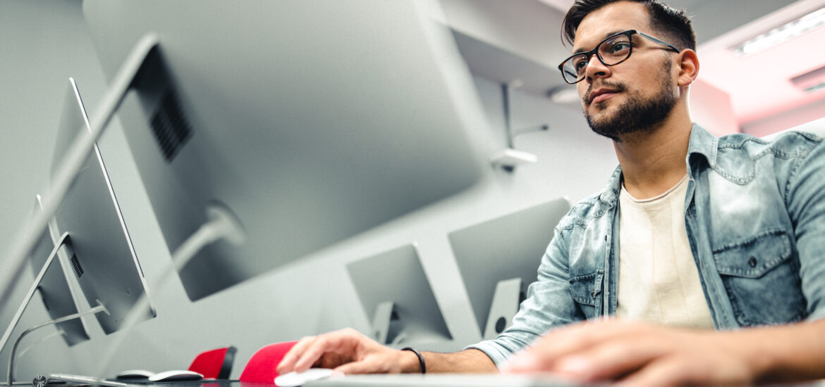 Student completing coursework for online computer information systems degree.