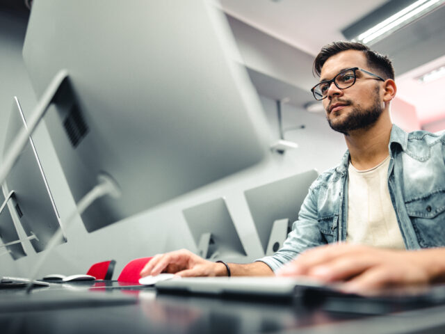 Student completing coursework for online computer information systems degree.