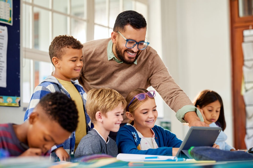 Teacher using digital tools with students to demonstrate innovation in online education master’s programs