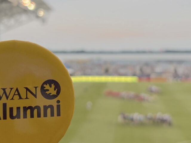 A Rowan University Alumni button in front of a Philadelphia Union game.
