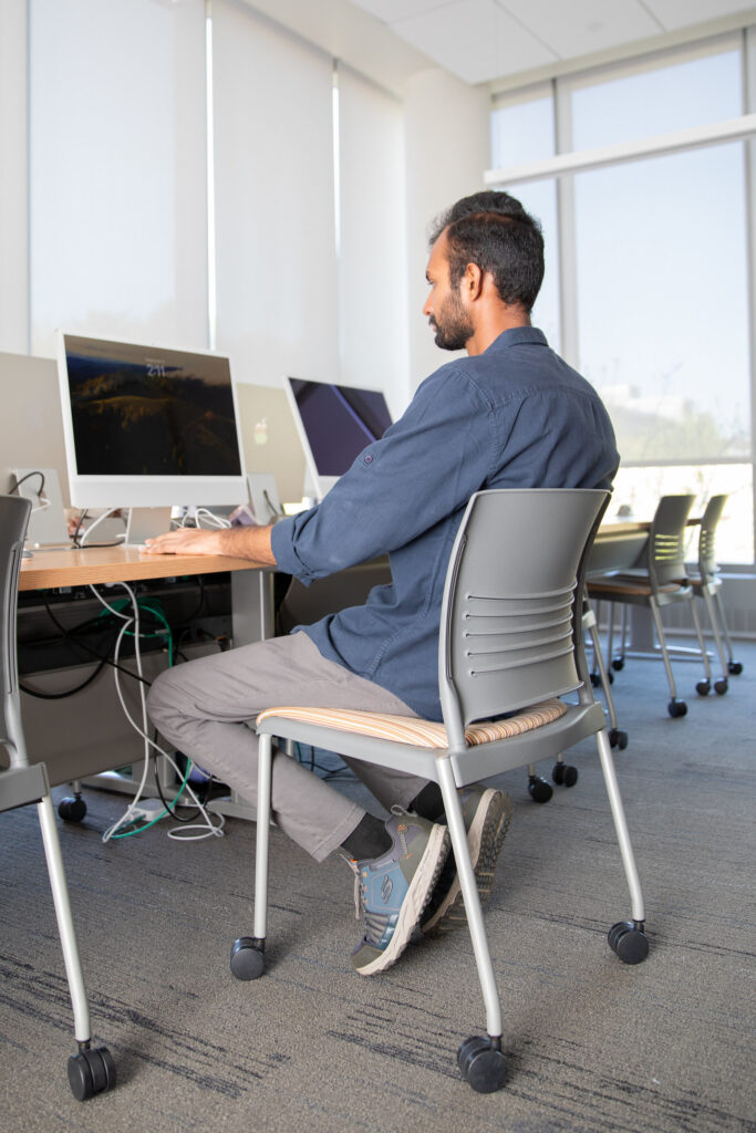 Graduate student completing online MBA coursework in a computer lab.