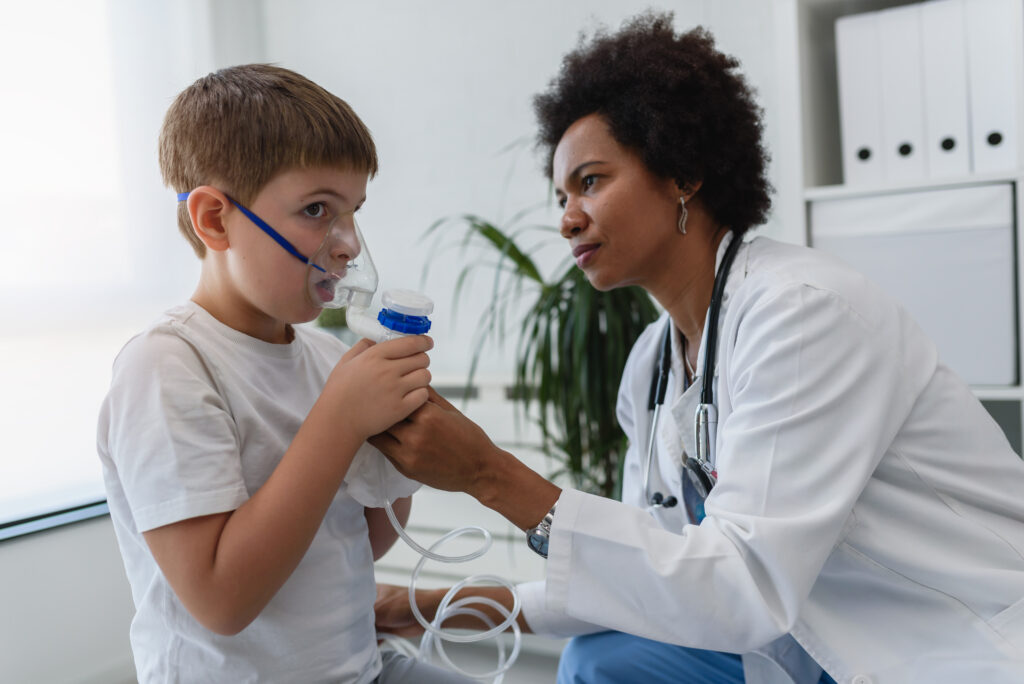Respiratory therapist caring for a child with a nebulizer, demonstrating skills taught in BSRT programs.