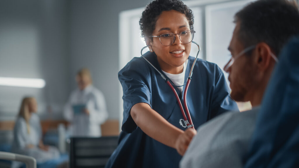 Respiratory therapist caring for a patient while advancing their career through accredited respiratory therapy programs online.