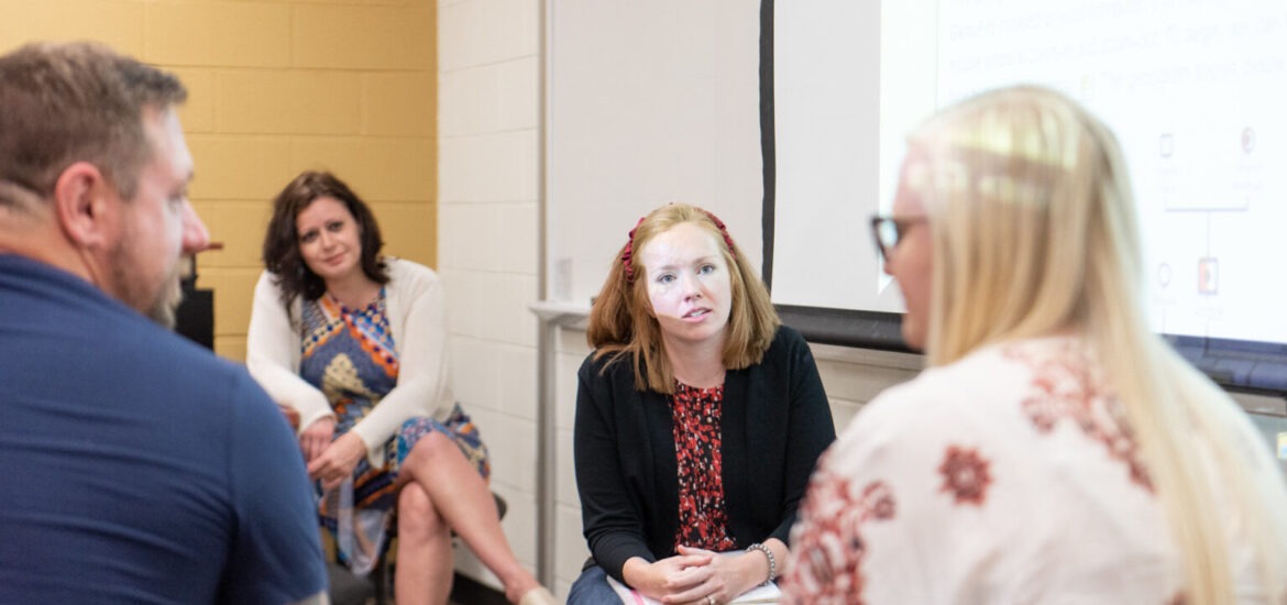 Psychology students engaged in small-group discussion at Rowan University, representing interactive learning in the psychology bachelor’s degree online.