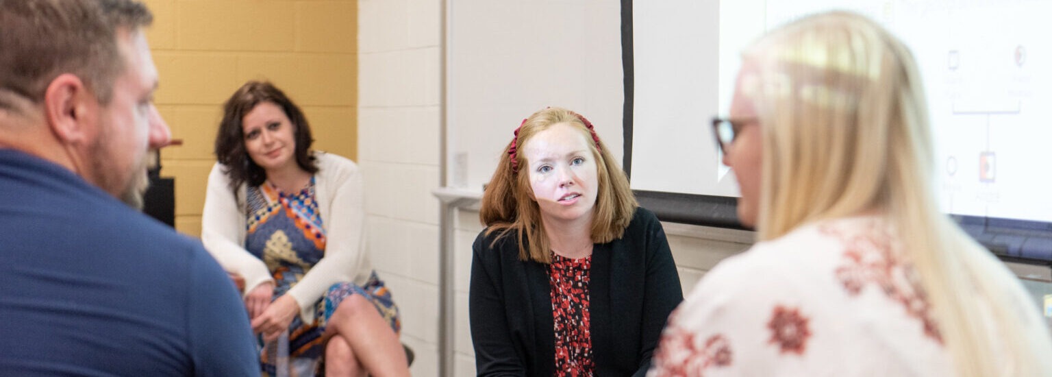Psychology students engaged in small-group discussion at Rowan University, representing interactive learning in the psychology bachelor’s degree online.