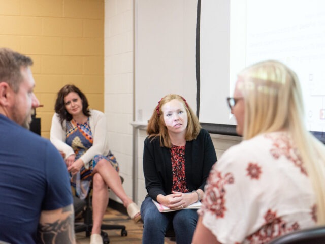 Psychology students engaged in small-group discussion at Rowan University, representing interactive learning in the psychology bachelor’s degree online.