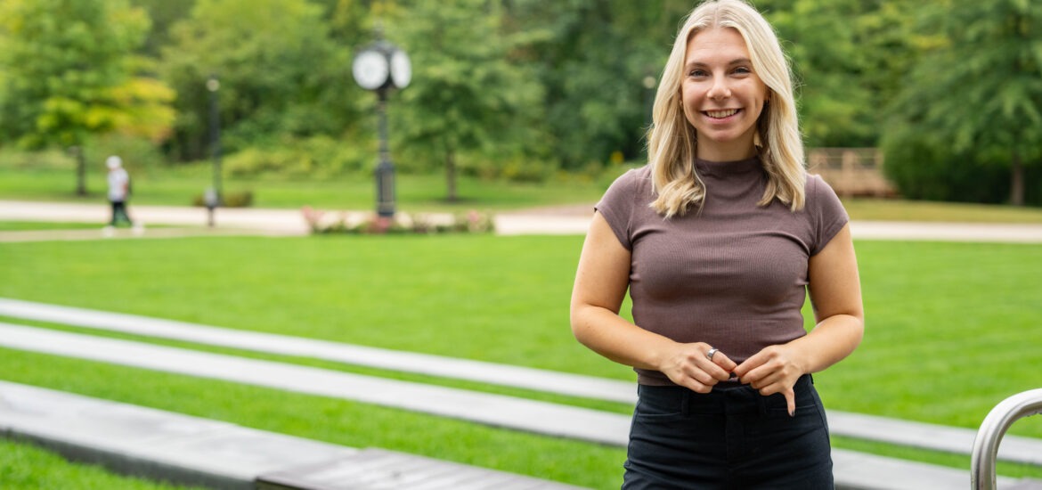 Online Ed.D. candidate at Rowan University smiling outside.