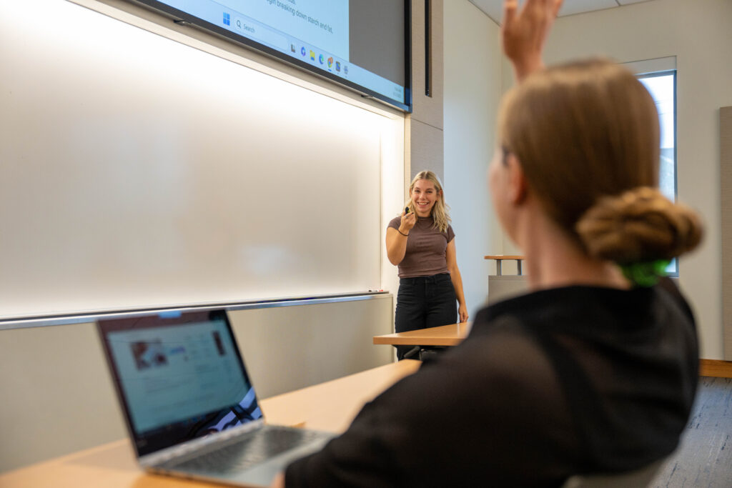 Online Ed.D. in higher education candidate, Samantha L., actively engaging with a student in the classroom.