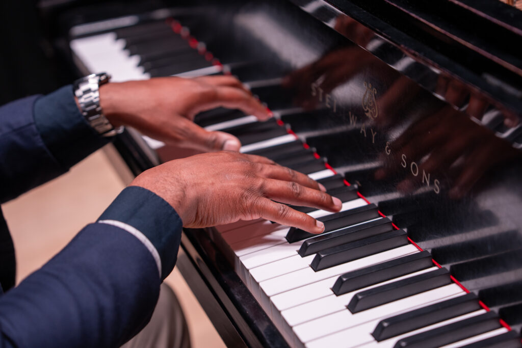 Close-up of Shawn B. playing piano, reflecting his passion for education and music while pursuing Rowan University’s online Ed.D. in Educational Leadership.