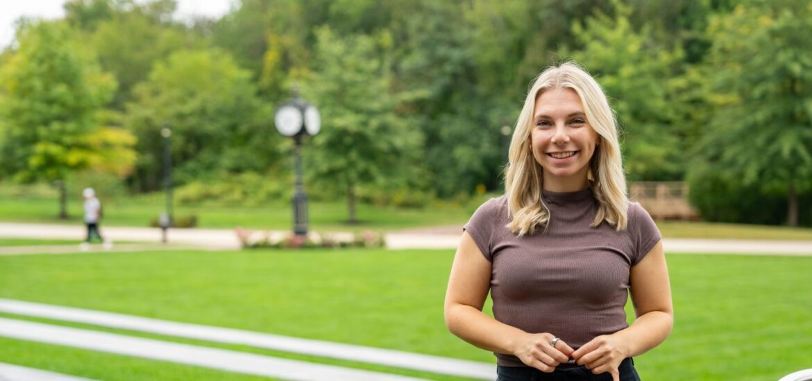 Online Ed.D. candidate at Rowan University smiling outside.