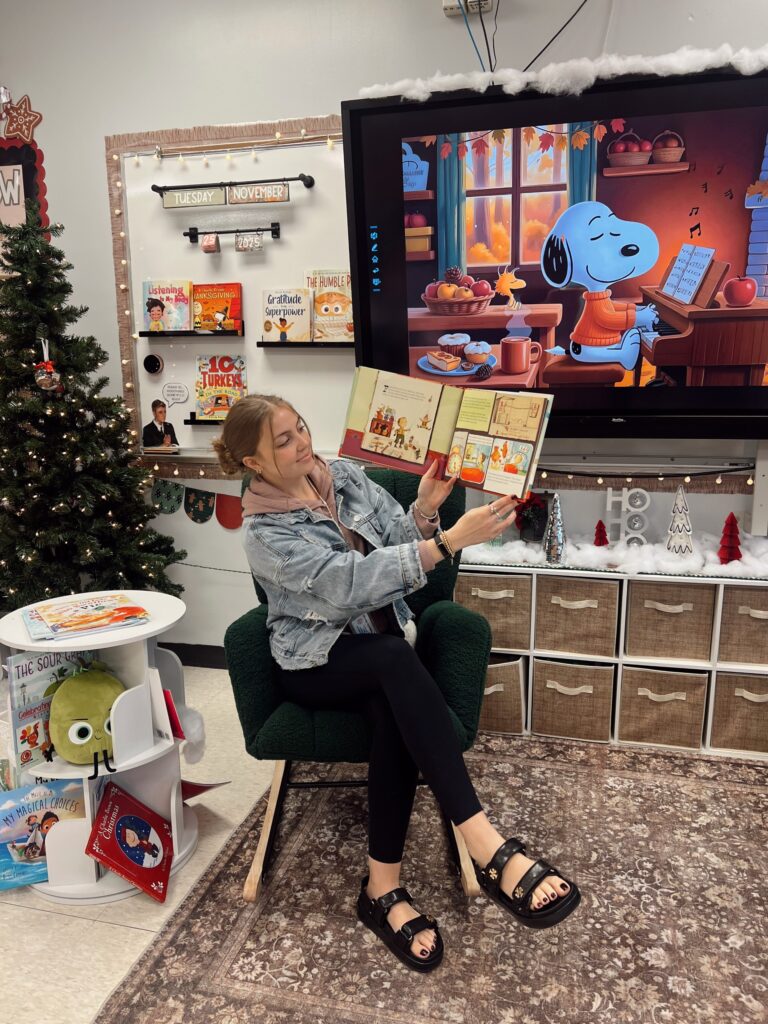 Online MA in Special Education student reading a book to her students in the classroom.