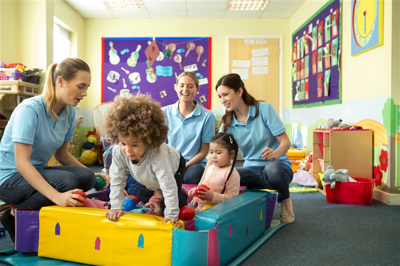 Teachers using skills from certificate in early childhood special education in a classroom with young children.