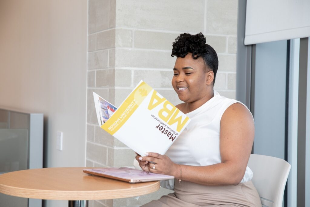 Prospective student reviewing Rowan University MBA program materials, representing commitment to professional growth and advanced business education.