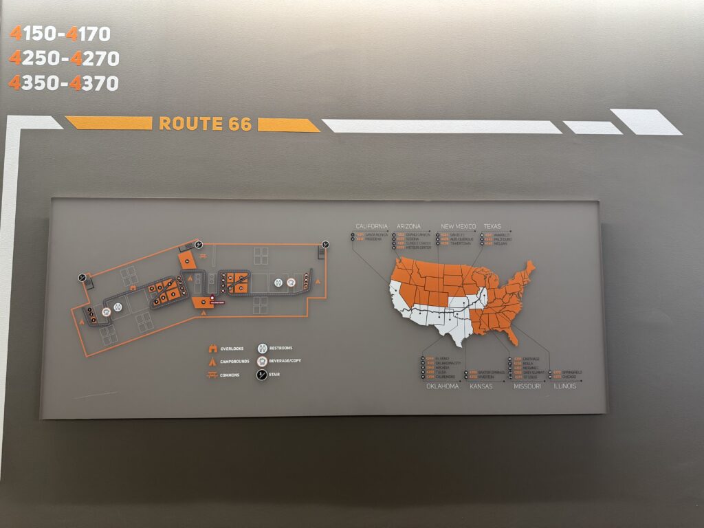 A Rowan information systems & analytics intern provided photo of a close up of the directional signage at Subaru of America headquarters. This sign is for the fourth floor, labeled Route 66, and shows a map of the United States, Route 66, and shares which conference room at Subaru is which Route 66 city. 