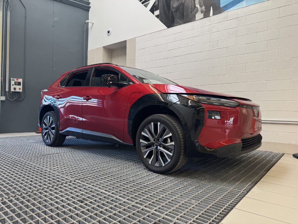 A Rowan information systems & analytics intern provided photo of a red, shiny EV car on display at Subaru of America headquarters. 
