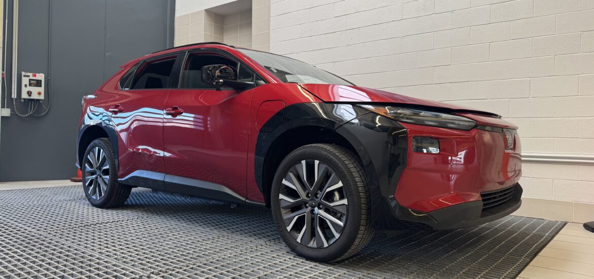 A Rowan information systems & analytics intern provided photo of a red, shiny EV car on display at Subaru of America headquarters.