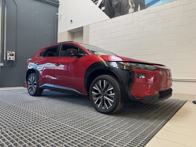 A Rowan information systems & analytics intern provided photo of a red, shiny EV car on display at Subaru of America headquarters.