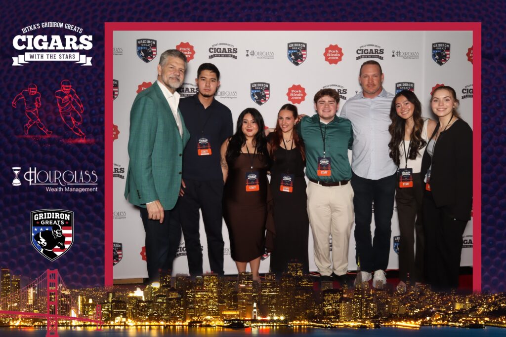 Six Rowan University sports communication and media students pose at the Cigars at the Stars pre-Super Bowl event with Mike Golic Sr and Brian Urlacher. 