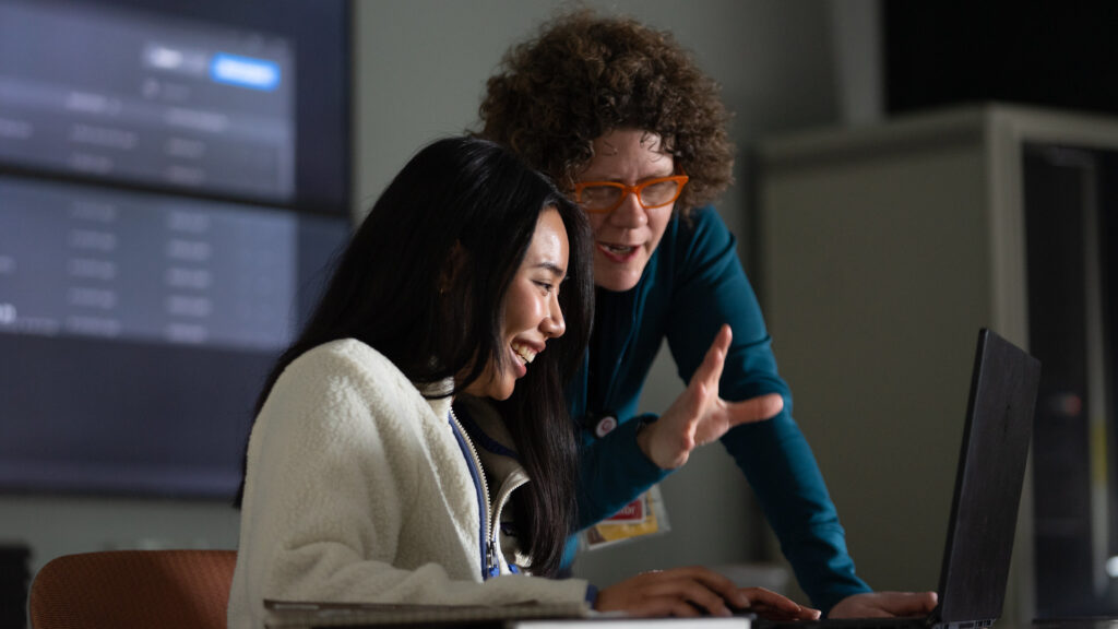 Rowan graduate student and professor interacting during a classroom lesson.