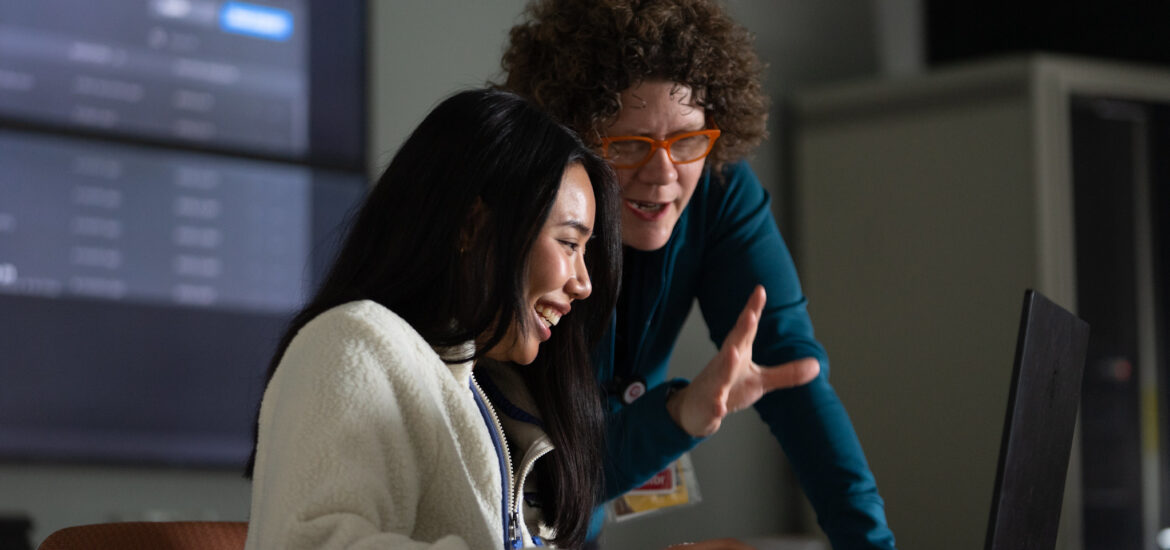 Rowan graduate student and professor interacting during a classroom lesson.
