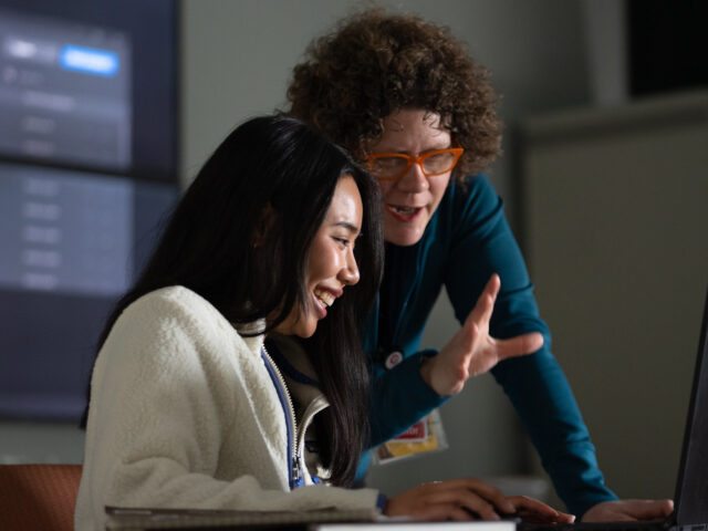 Rowan graduate student and professor interacting during a classroom lesson.