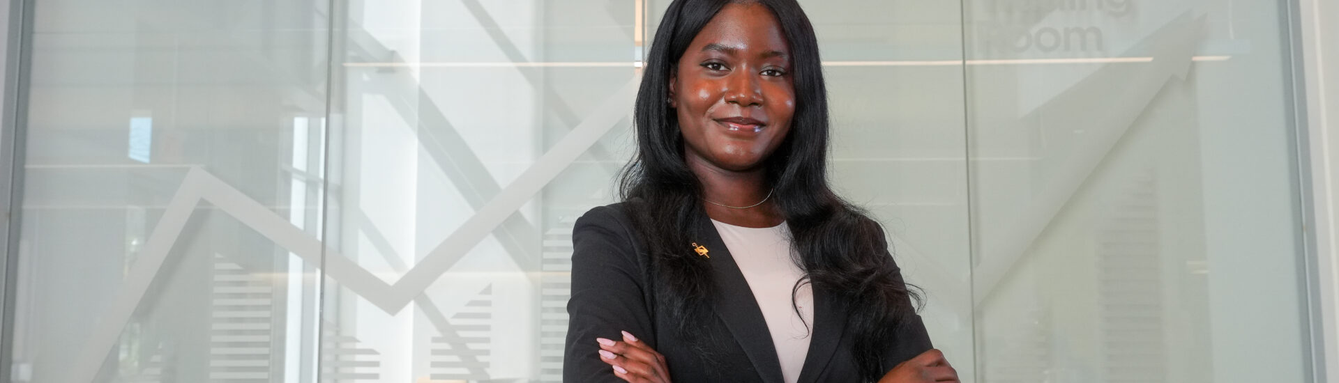 Taiwo, a finance major, poses for a photo at Business Hall.