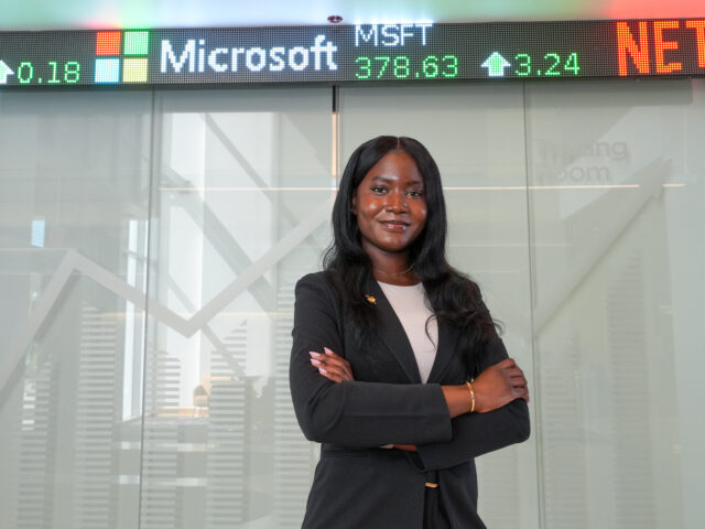 Taiwo, a finance major, poses for a photo at Business Hall.