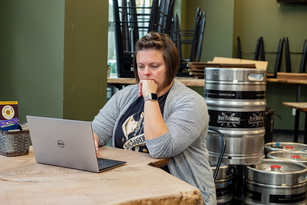 Rowan Online student completing coursework on laptop in between work shifts.
