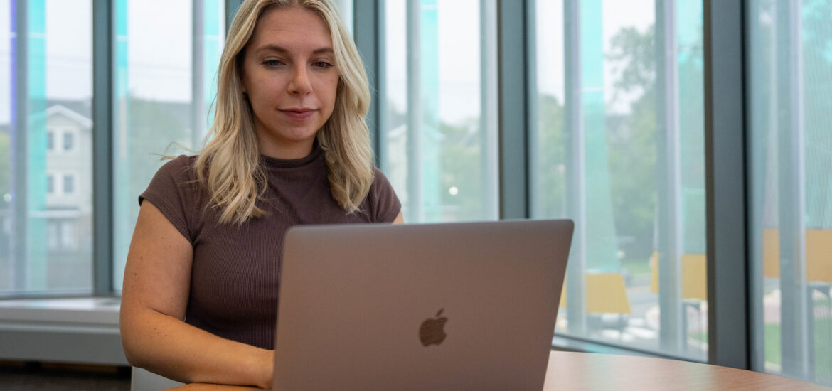 Student using a laptop while studying in an online college program at Rowan University.