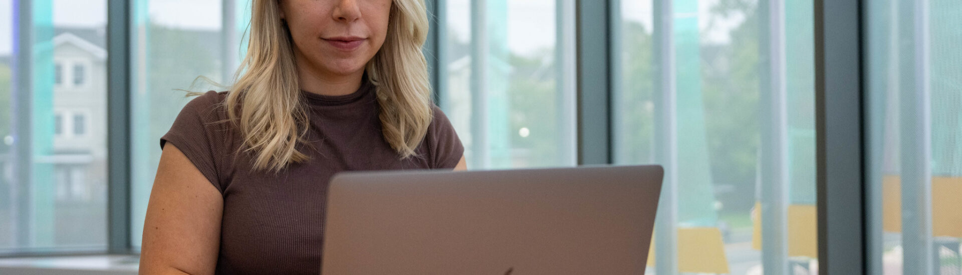 Student using a laptop while studying in an online college program at Rowan University.