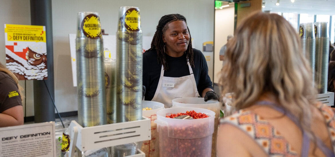 Tashir B., in action., with students serving his popcorn blend from his small business, The Ballard Bakery.