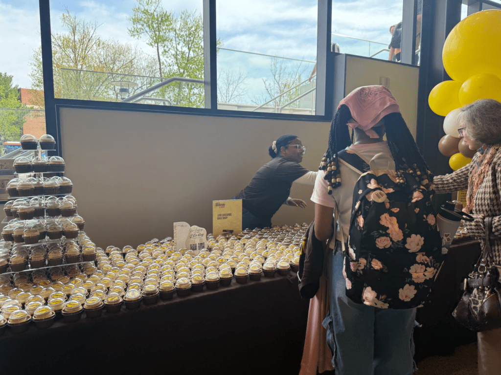 Mahogany from Love Language Bake Shop serving cupakes at Rowan University's campus-wide Defy Definition event.