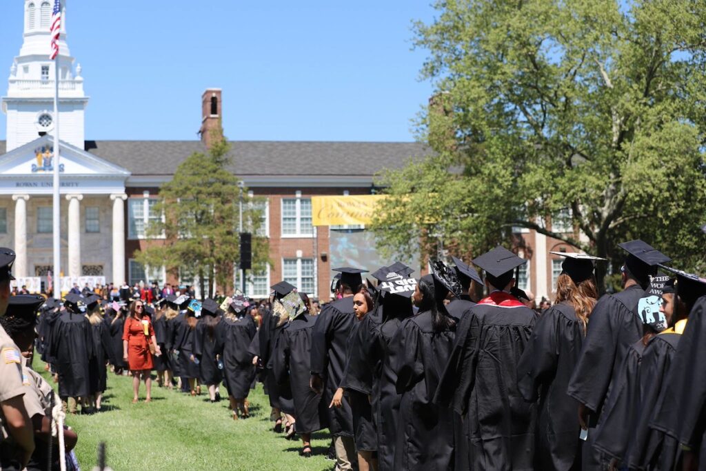 A graduating class at a Rowan University graduation ceremony years ago walk into the ceremony. 