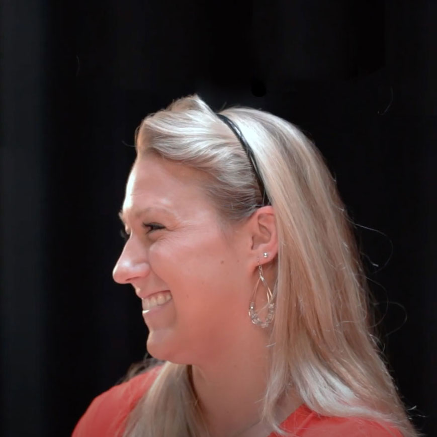 Jessica H. smiles for a portrait.