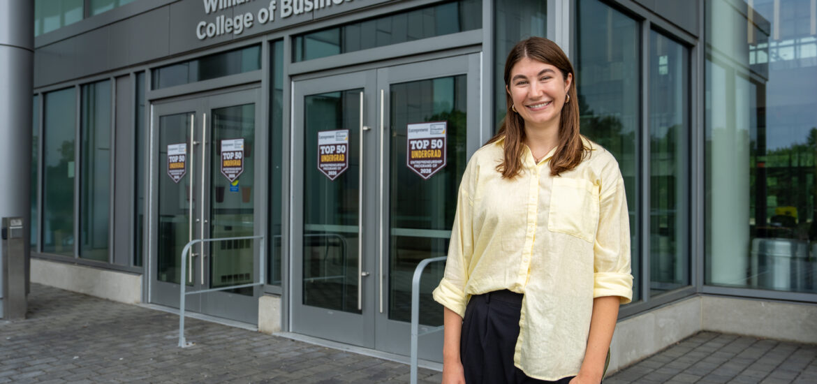 Marketing and entrepreneurship alumna Megan S. smiling outside Rowan University’s William G. Rohrer College of Business.